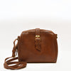 Front view of bag, handle down, brown leather, Sam Leather Crossbody Bag.